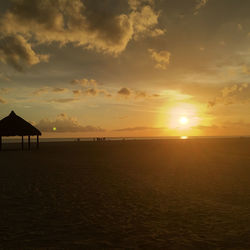 Scenic view of beach against sky during sunset