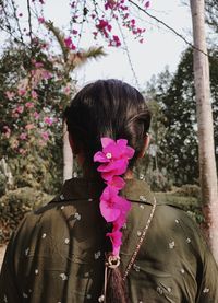 Rear view of woman wearing flowers