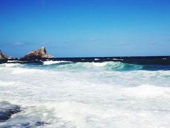 Scenic view of sea against blue sky