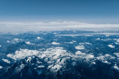 Aerial view of snowcapped mountains against sky