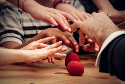 Cropped hands of people playing on table