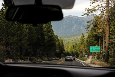 Cars on road seen through car windshield