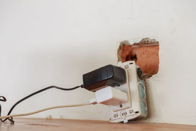 Close-up of electrical outlet by wall