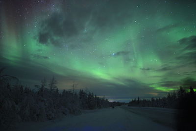 Scenic view of snowy landscape against sky at night