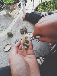 High angle view of man holding hands on table