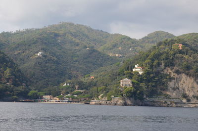 Scenic view of sea and mountains against sky