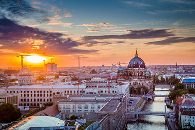 Buildings against sky during sunset in city