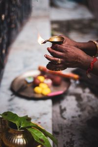 Hands holding diya oil lamp