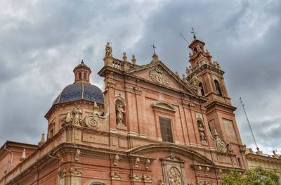 Low angle view of cathedral against cloudy sky