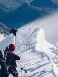 High angle view of people skiing on snow covered landscape