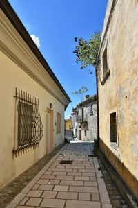 A narrow street among the old houses of greci, a village in the campania region, italy.