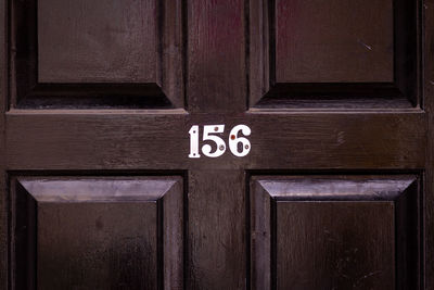 Close-up of text on wooden door