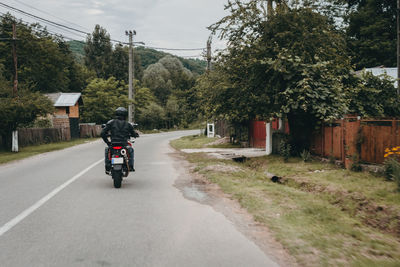 Man riding motorcycle on road