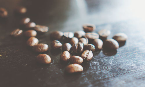 Close-up of roasted coffee beans on table