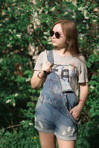 Young woman wearing sunglasses standing outdoors