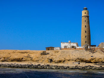 View of lighthouse against clear blue sky