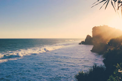 Scenic view of sea against clear sky during sunset