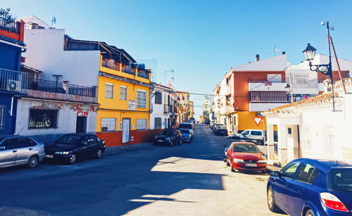 Cars on street against buildings in city