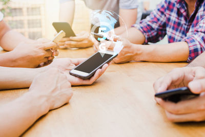 Midsection of man using mobile phone