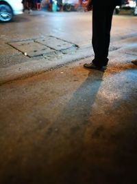 Low section of man with reflection on road