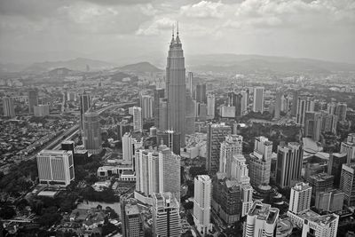 Cityscape against cloudy sky