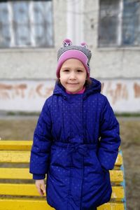 Portrait of cute girl standing in winter