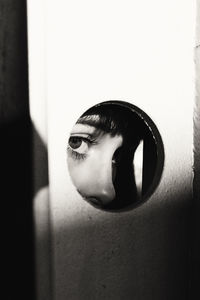 Close-up portrait of young woman against wall