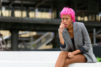 Portrait of woman sitting outdoors