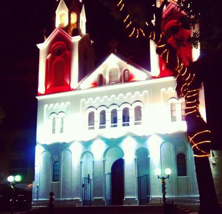 building exterior, architecture, built structure, low angle view, night, place of worship, illuminated, religion, spirituality, church, facade, lighting equipment, tree, outdoors, arch, temple - building, sky, street light