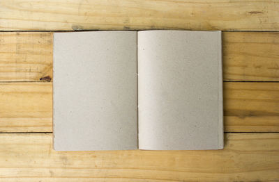Directly above view of blank diary on wooden table