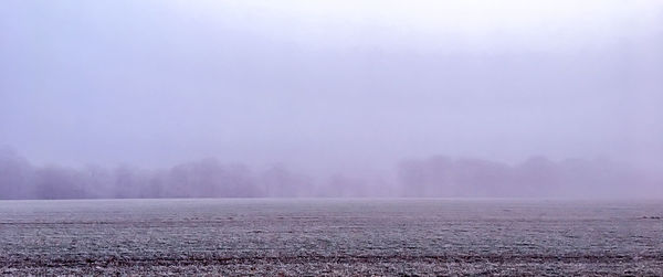 Scenic view of landscape against sky during winter