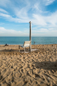 Lifeguard hut on beach against sky