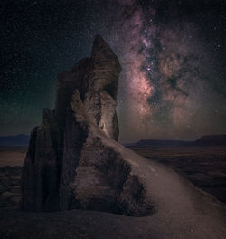 Low angle view of rock formations against sky at night