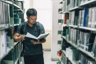 Young man reading book