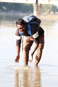 Portrait of man bending in lake