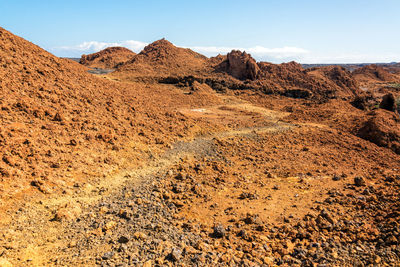 Scenic view of barren landscape at santiago island against sky