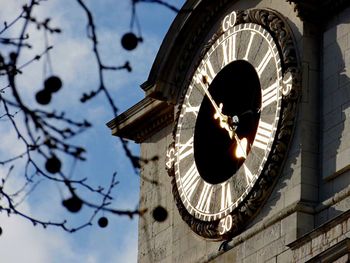 Low angle view of clock tower against sky