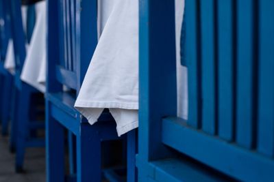 Close-up of clothes hanging against blue sky