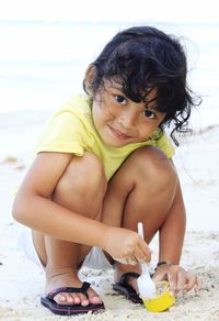 Cute girl  sitting on beach