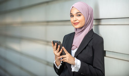 Portrait of a young woman using mobile phone