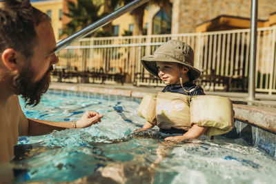 Woman sitting in swimming pool