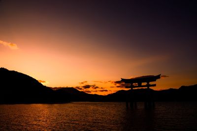 Scenic view of lake against orange sky