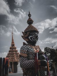 Statue of temple against building