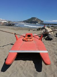 Deck chairs on beach against clear sky