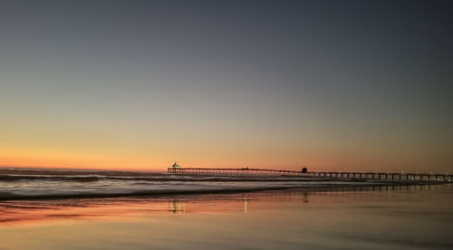 Scenic view of sea against clear sky during sunset