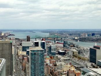 High angle view of buildings and sea against sky