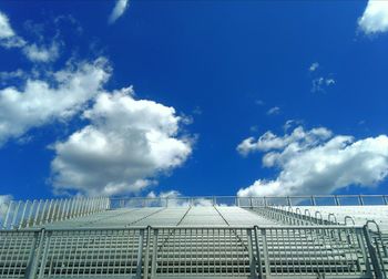 Empty stadium seats against sky