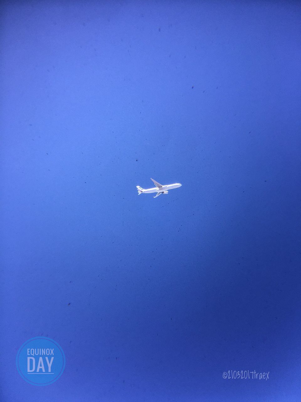 AIRPLANE FLYING OVER BLUE SKY