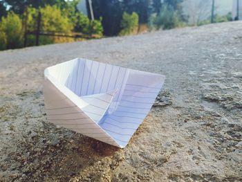 Close-up of paper boat on road