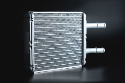 New interior heater radiator on a black background. aluminum radiator. spare parts